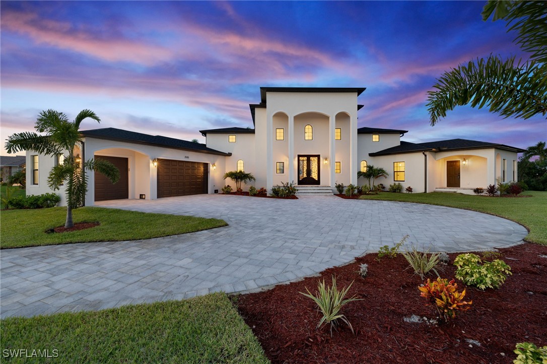 a front view of a house with a yard and garage