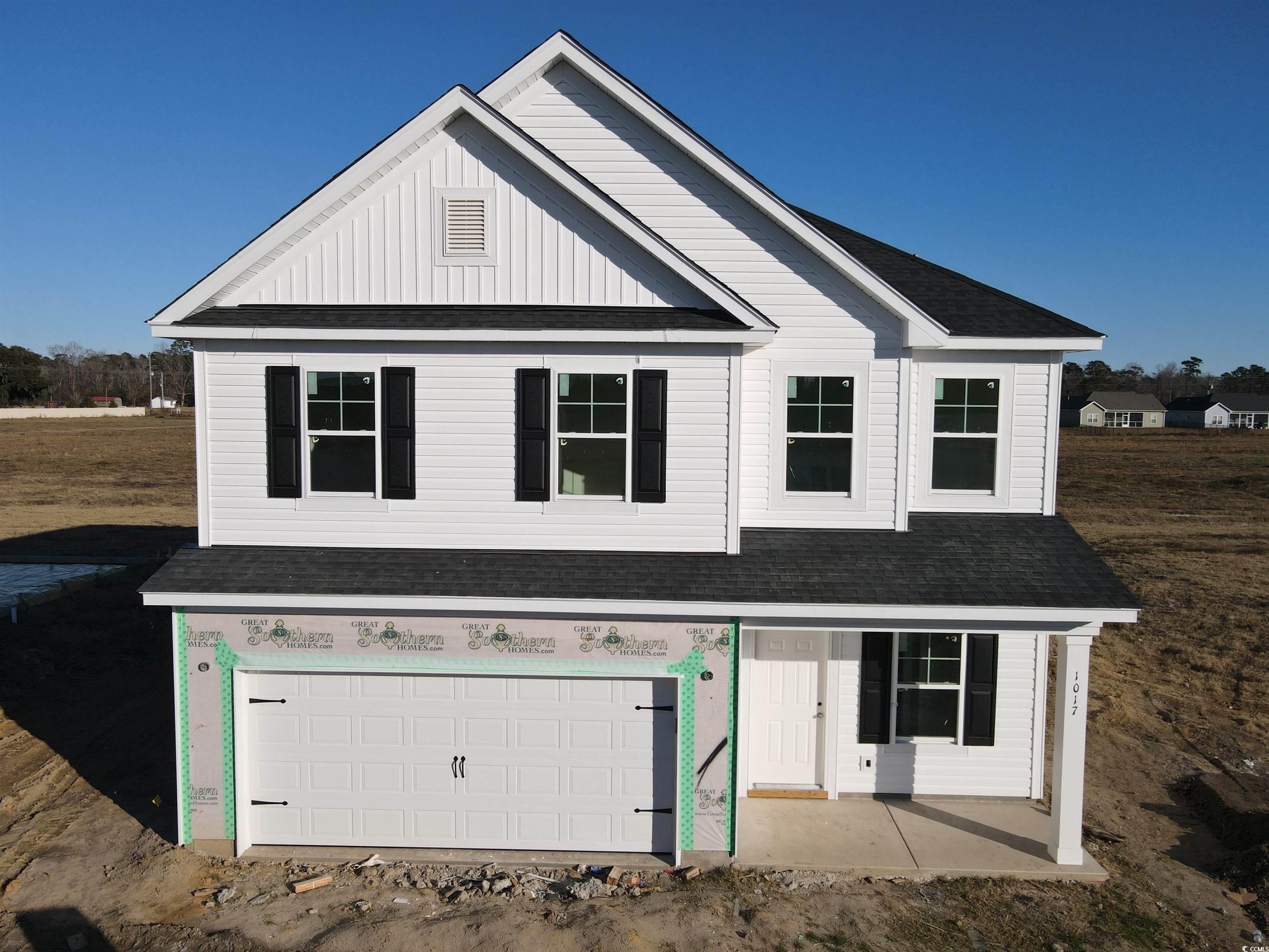 View of front facade featuring a garage