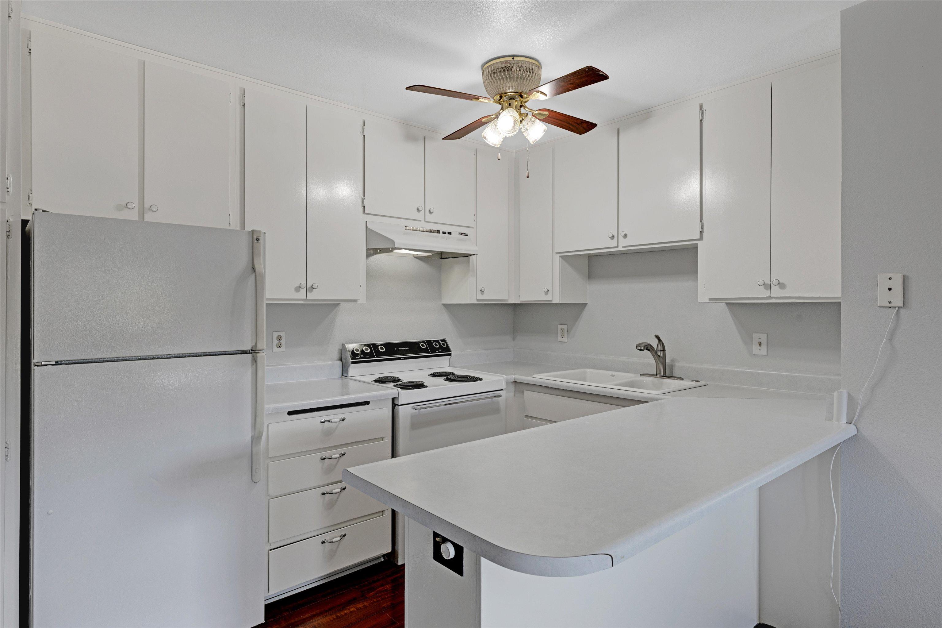 a kitchen with stainless steel appliances a stove a sink and cabinets