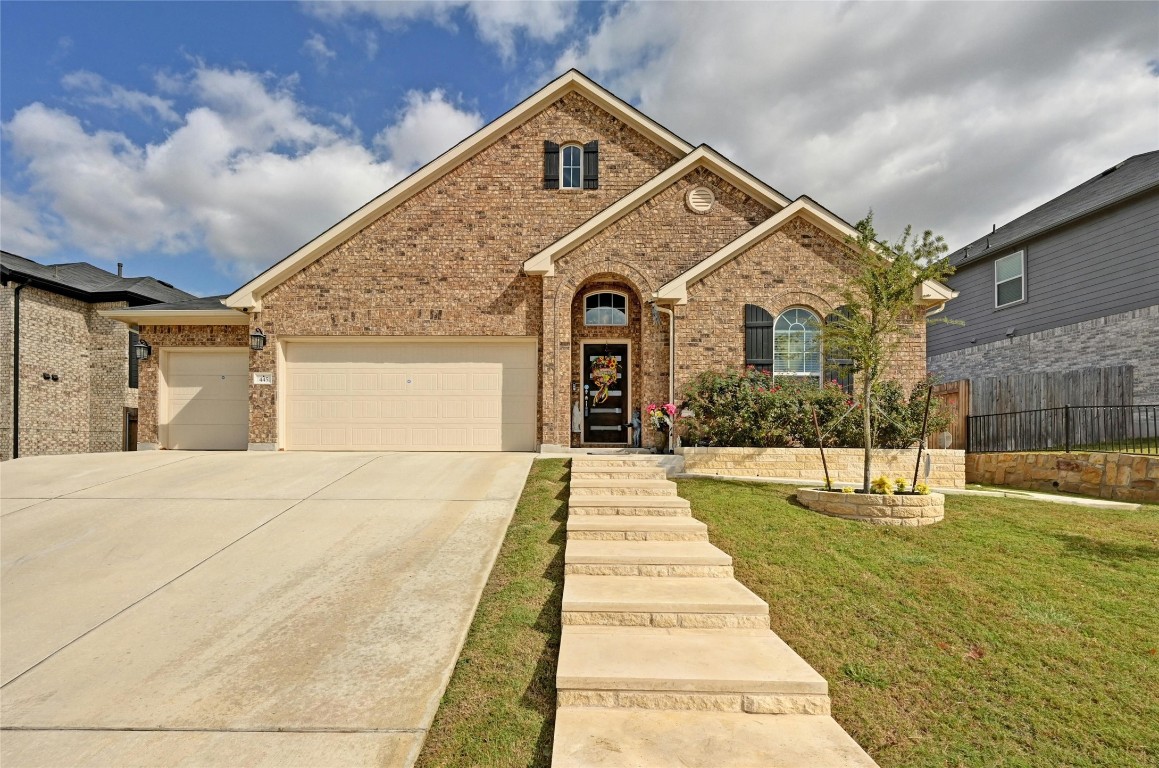 a front view of a house with a yard