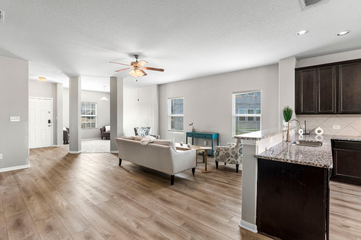 a living room with granite countertop furniture a fireplace and a large window