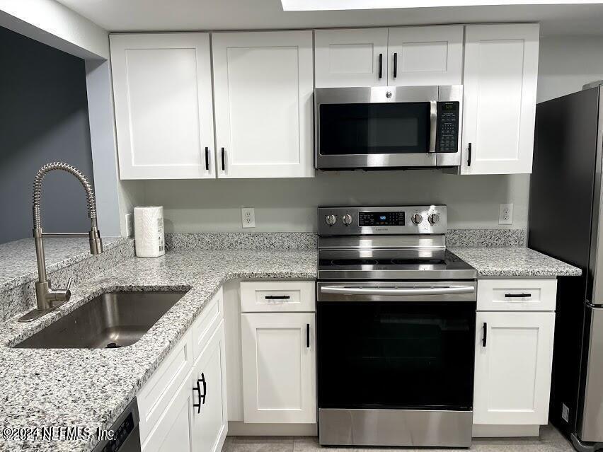 a kitchen with a stove and a microwave