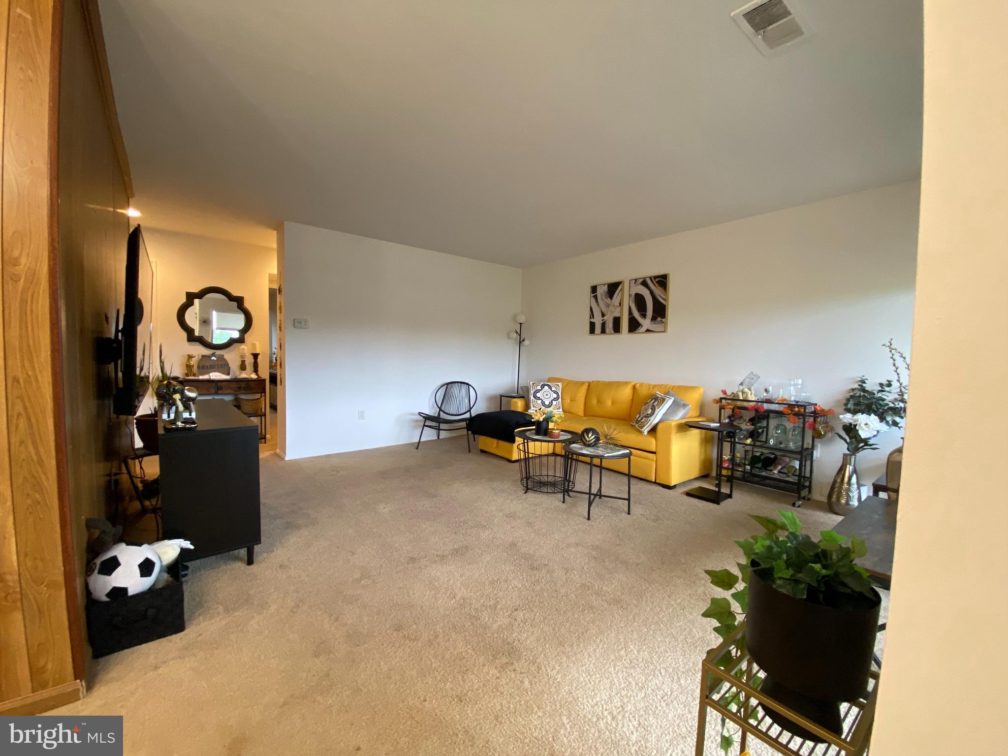 a view of a livingroom with furniture and a gym equipment