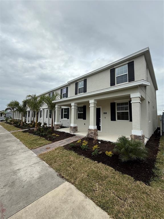 a front view of a house with yard porch and outdoor seating