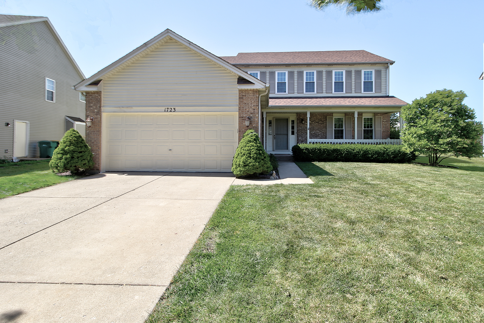 a front view of brick house with a yard