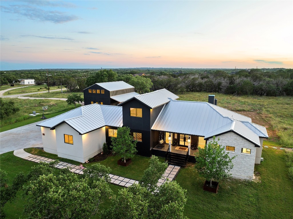 an aerial view of a house with a big yard