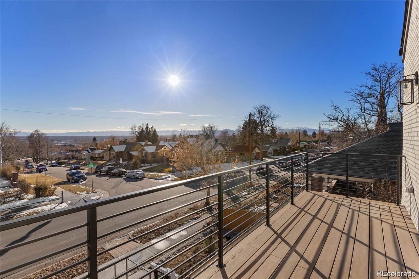 a view of a balcony with wooden floor and city view