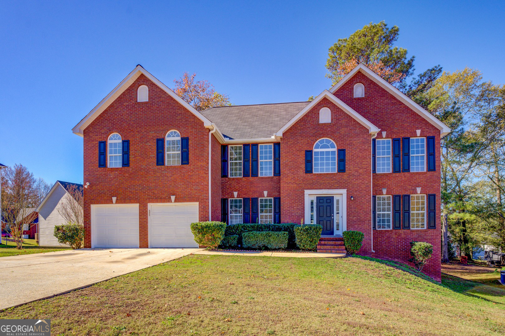 front view of brick house with a yard