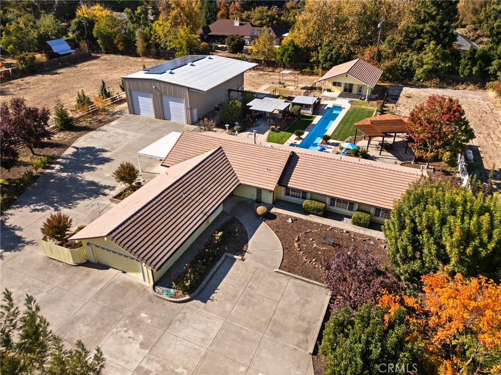 a aerial view of a house with a yard and sitting area