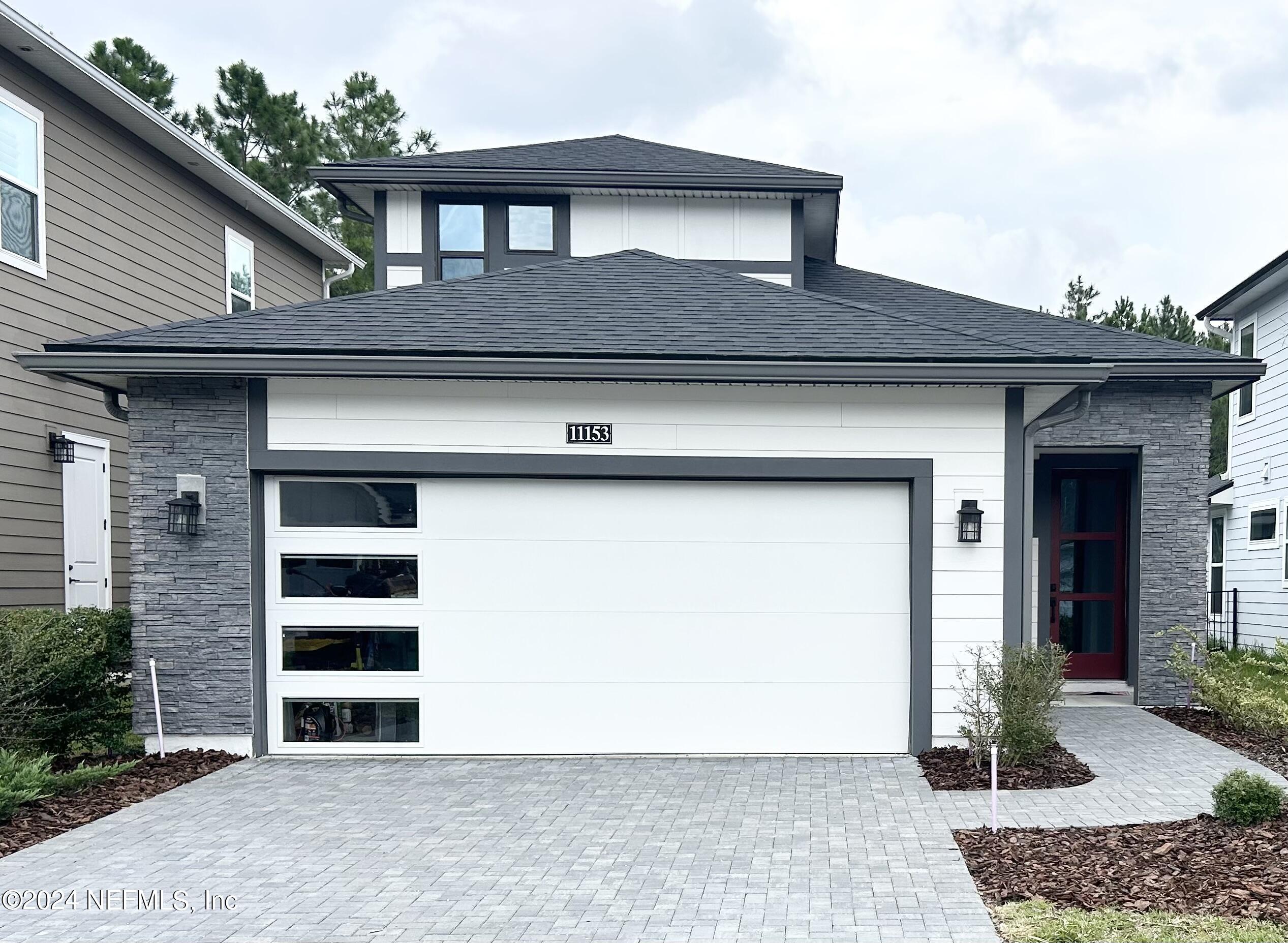 a front view of a house with garage