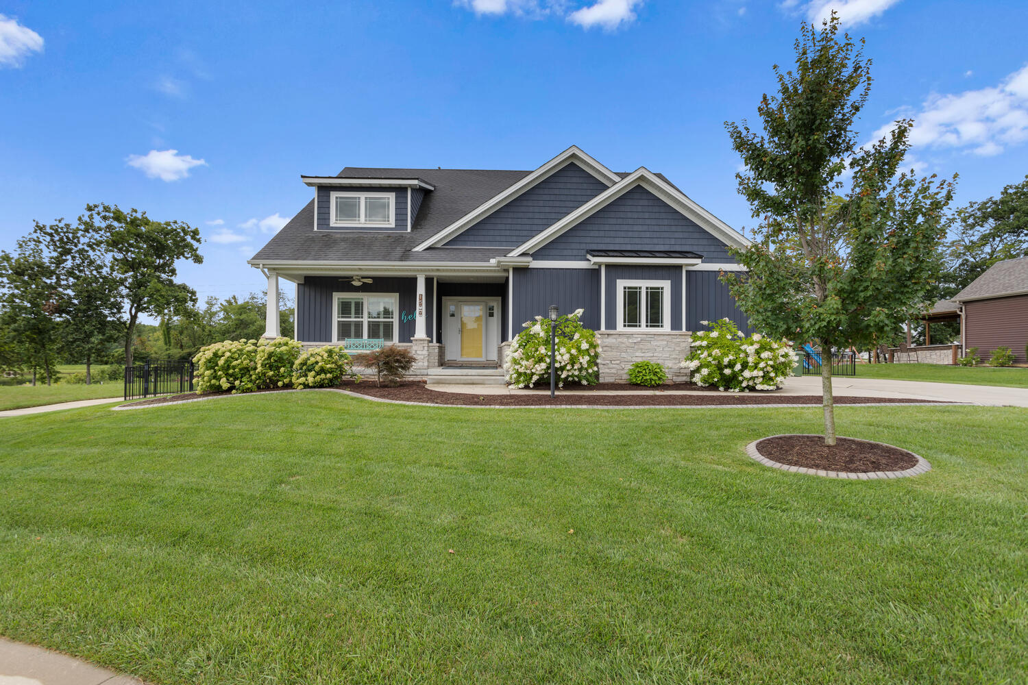 a front view of house with yard and green space