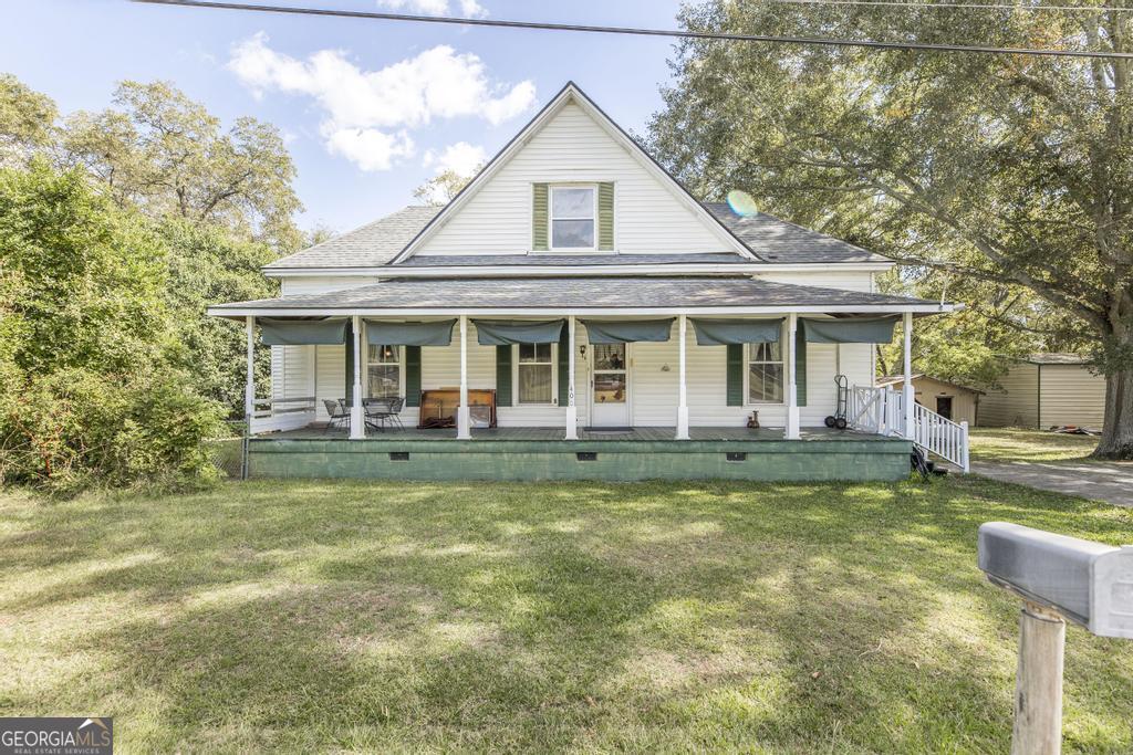 a front view of a house with a garden and porch