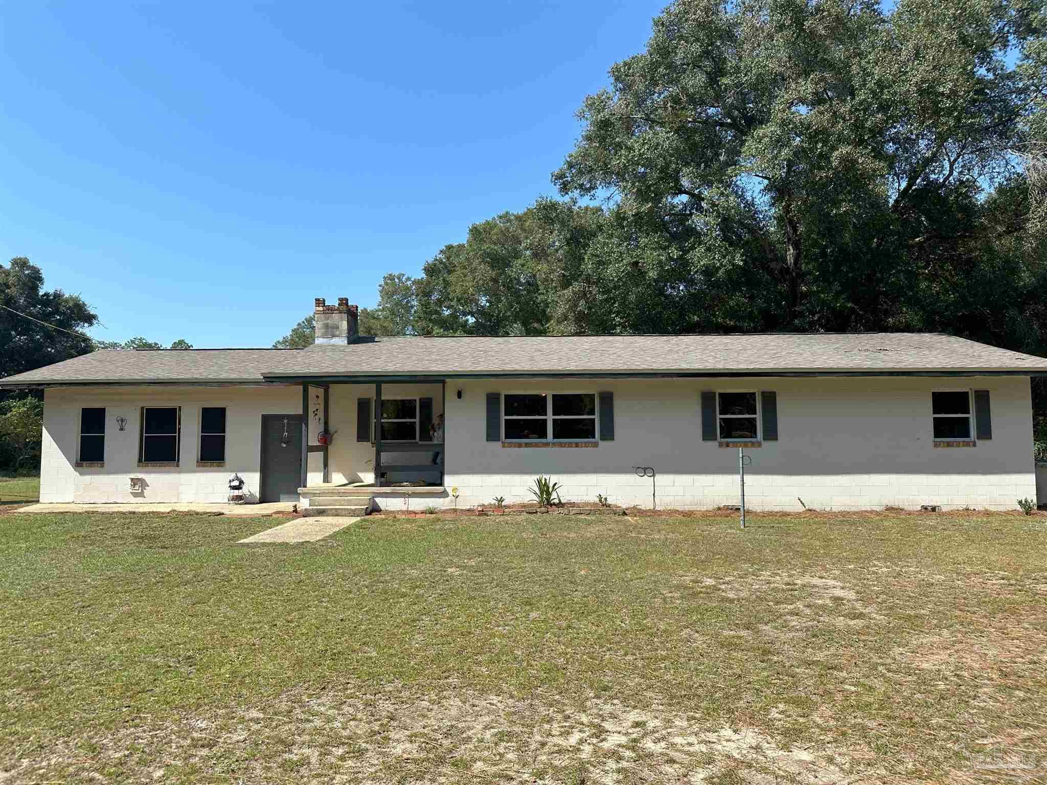 a house that has a large tree in front of it