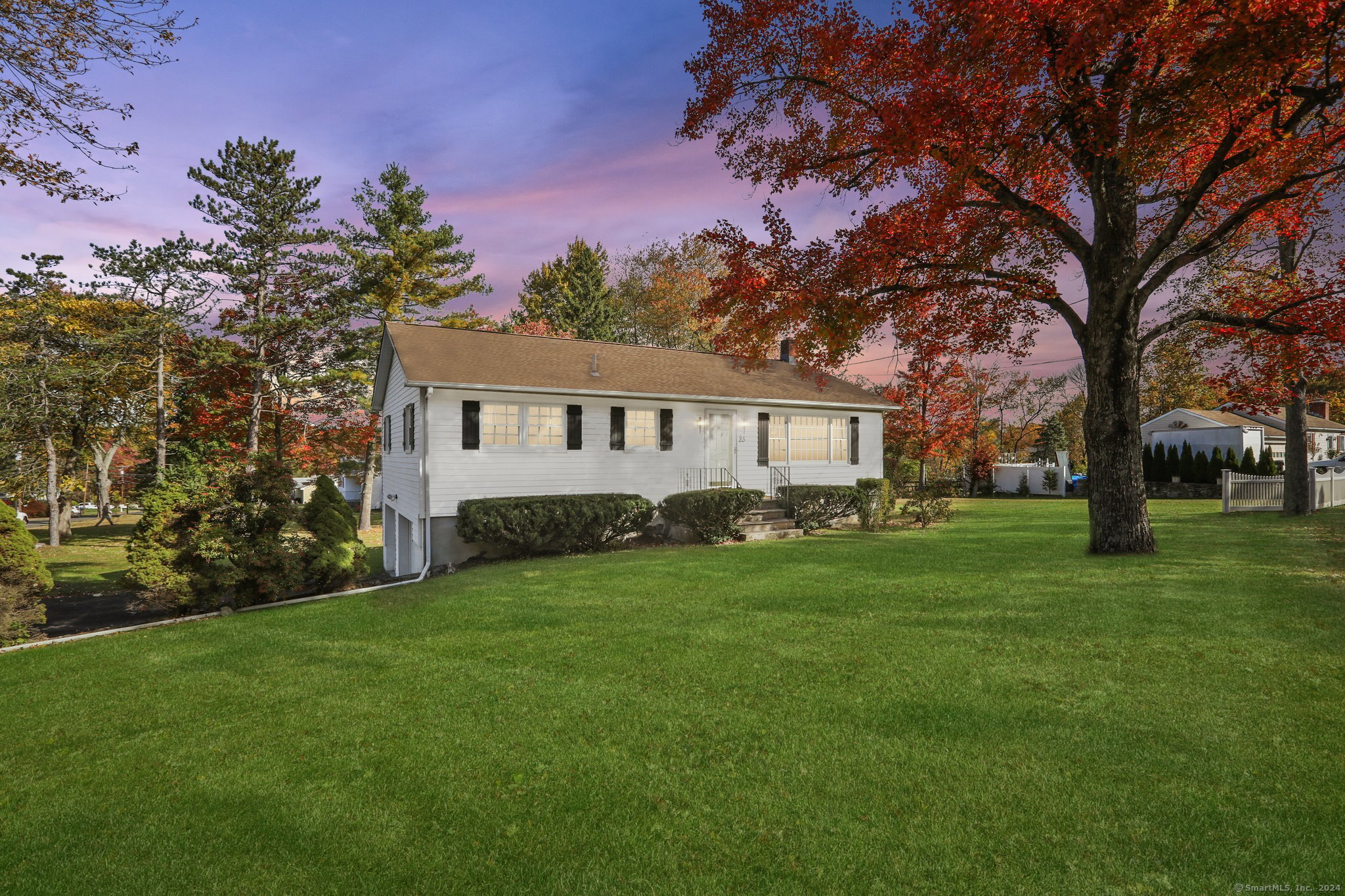 a front view of a house with a garden