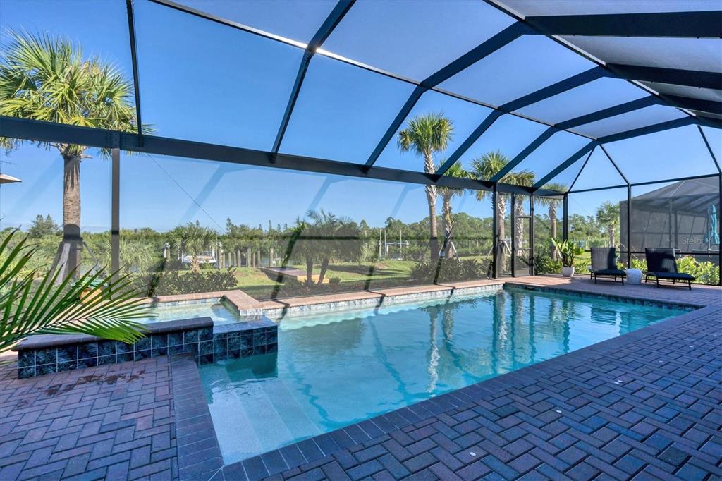 an outdoor view of swimming pool with outdoor seating