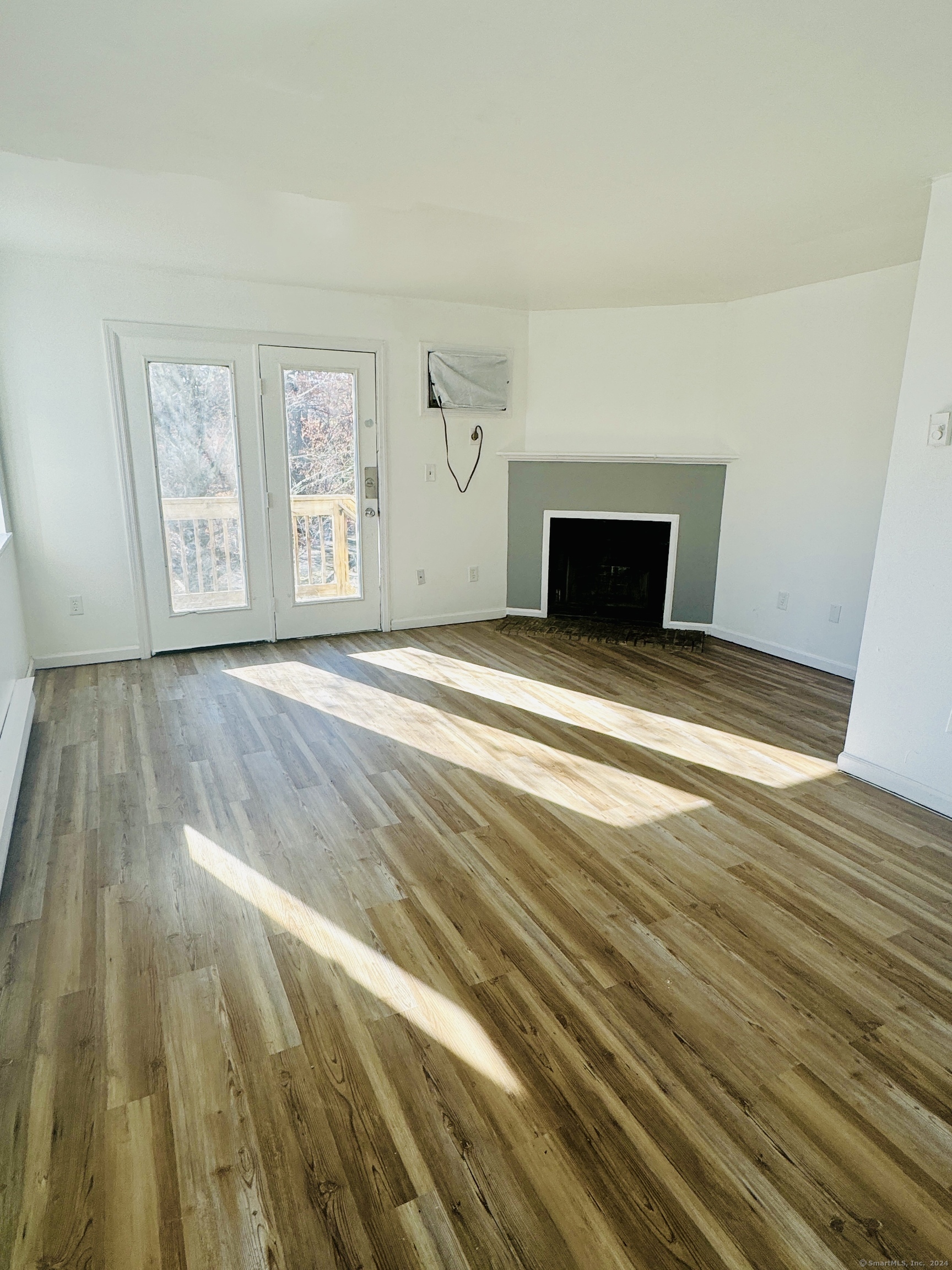 a view of empty room with window and fireplace