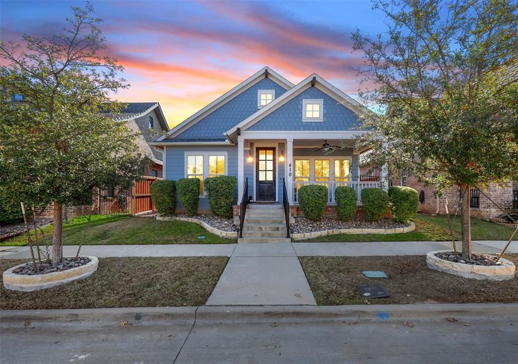 a front view of a house with yard and green space