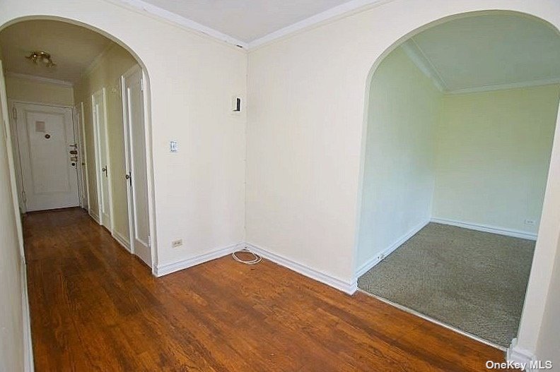 an empty room with wooden floor and a window