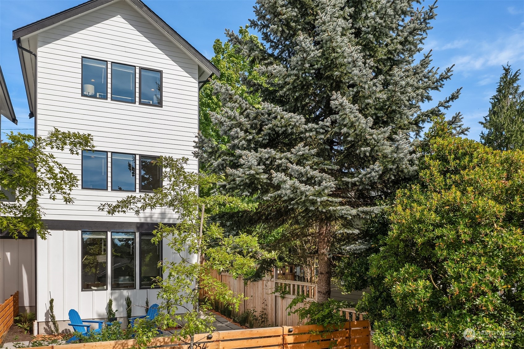 a view of house that has a tree in front of it