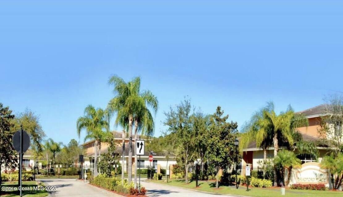 a view of city street with palm trees