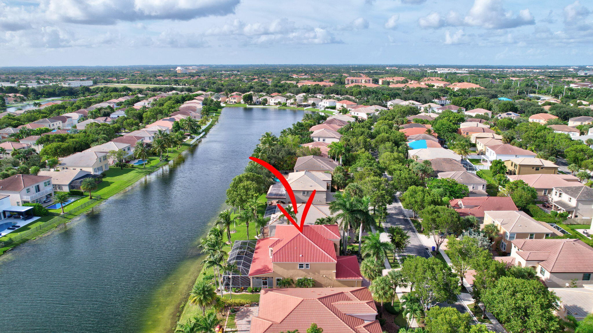 an aerial view of residential houses with outdoor space and lake view