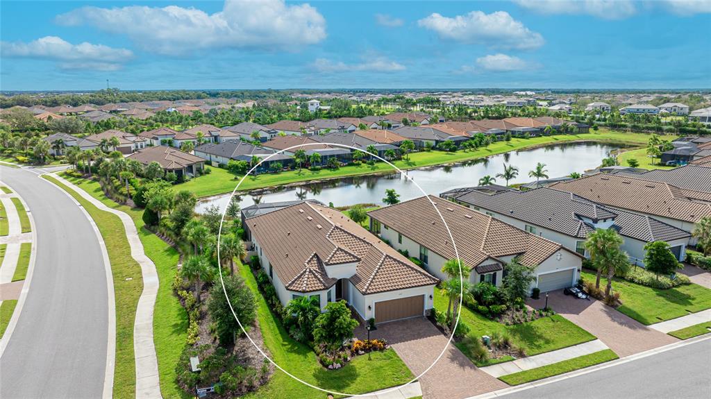 an aerial view of residential houses with outdoor space and swimming pool