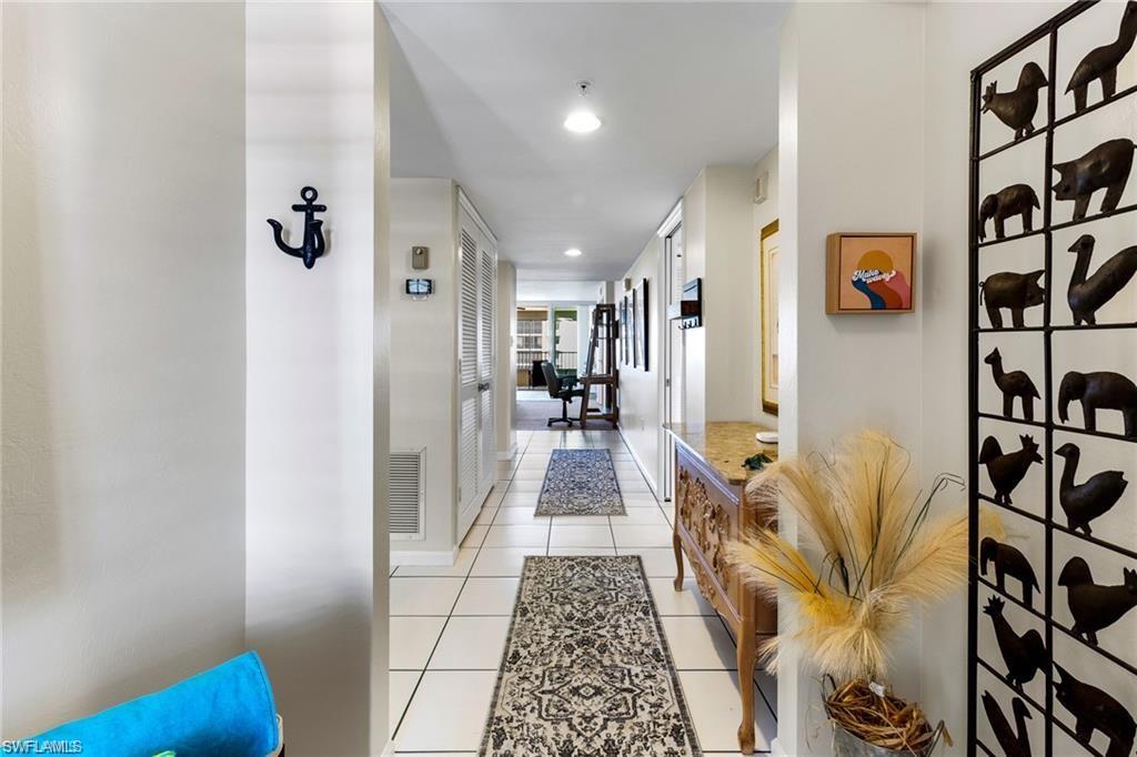 a hallway with furniture and wooden floor