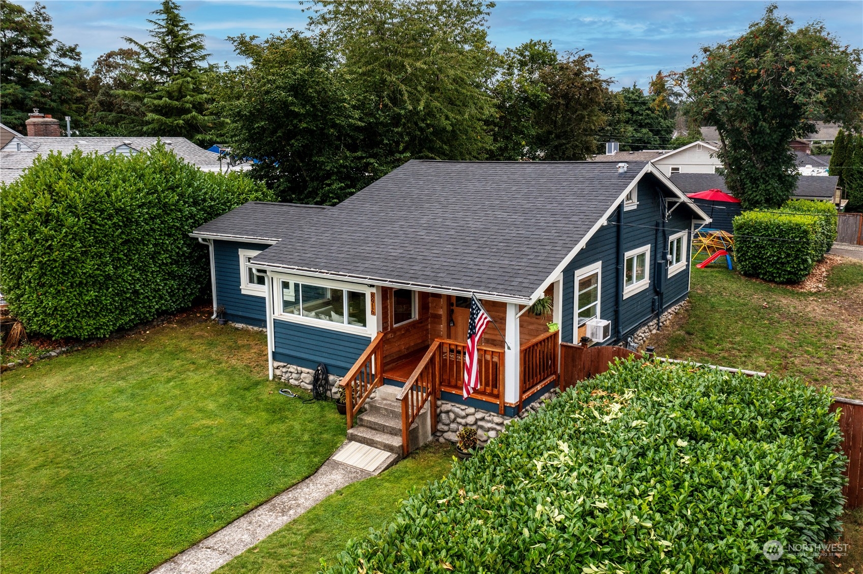 an aerial view of a house with swimming pool and garden