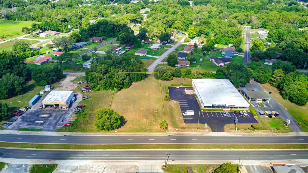 an aerial view of residential houses with yard and swimming pool