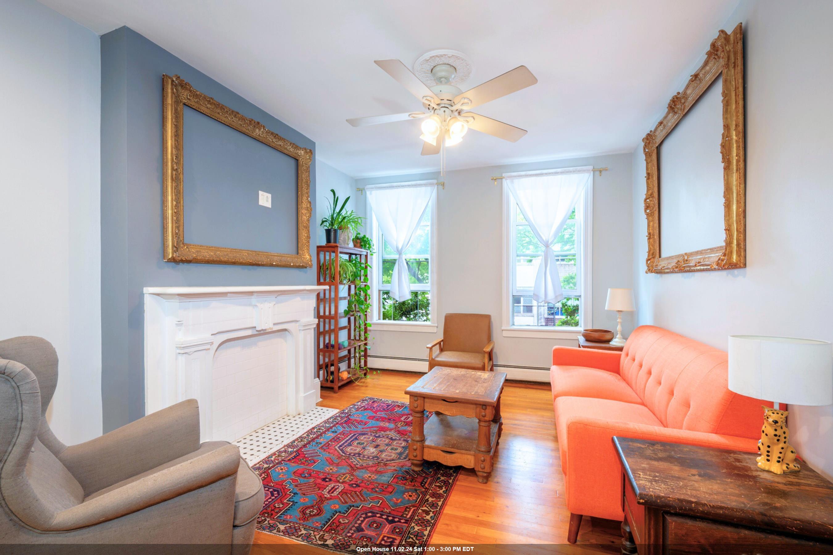 a living room with furniture fireplace and a large window