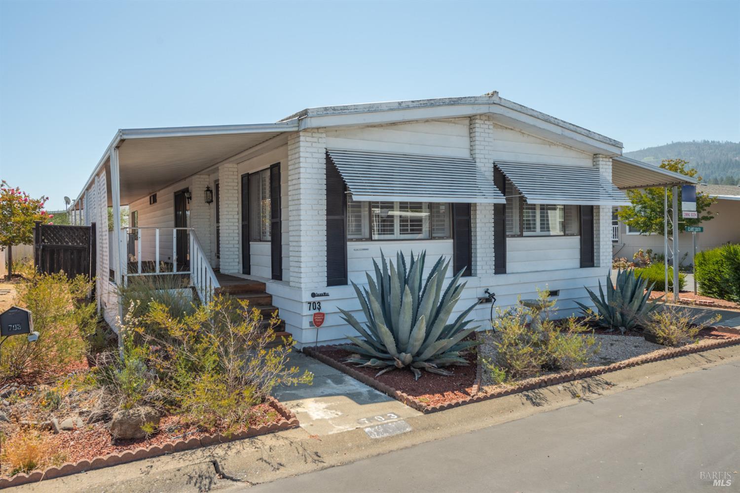 front view of a house with potted plants