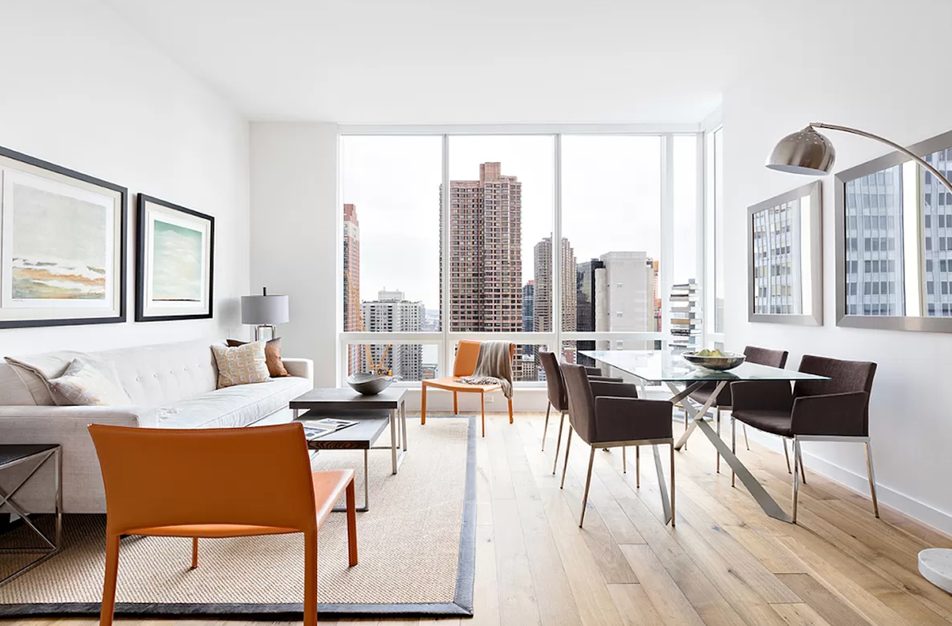 a living room with furniture and floor to ceiling windows