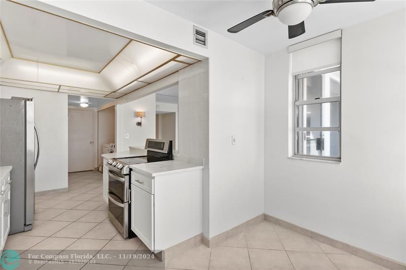 a kitchen with a stove a refrigerator and a cabinets