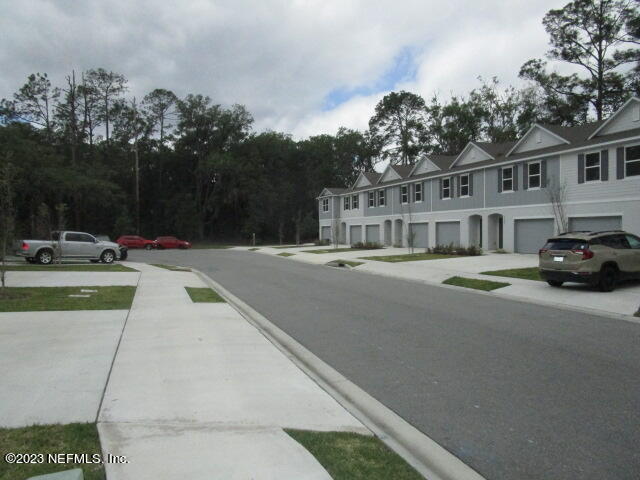 a view of multiple houses with a street