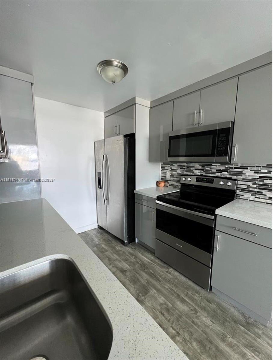 a kitchen with a stove and a refrigerator