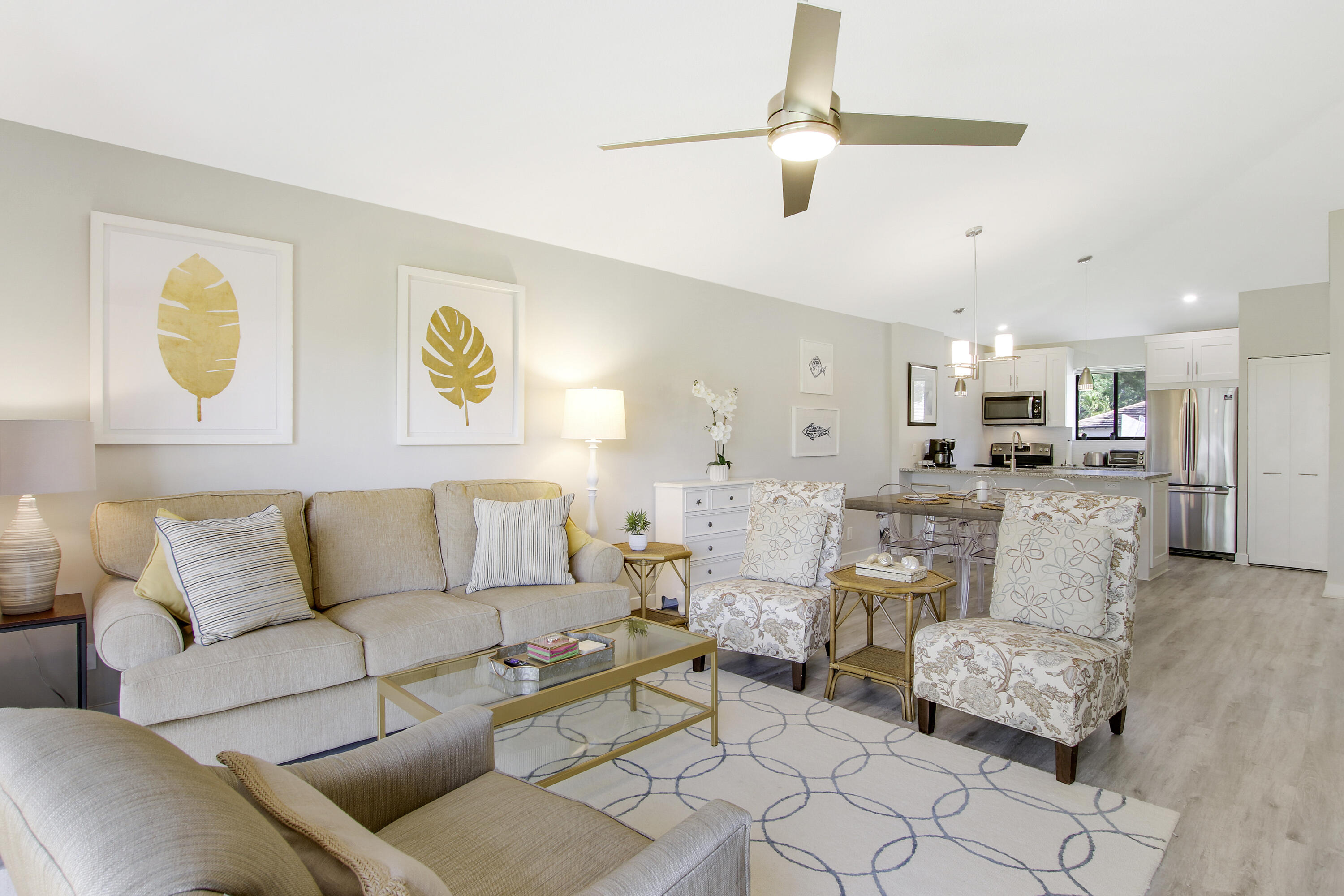 a living room with furniture and kitchen view