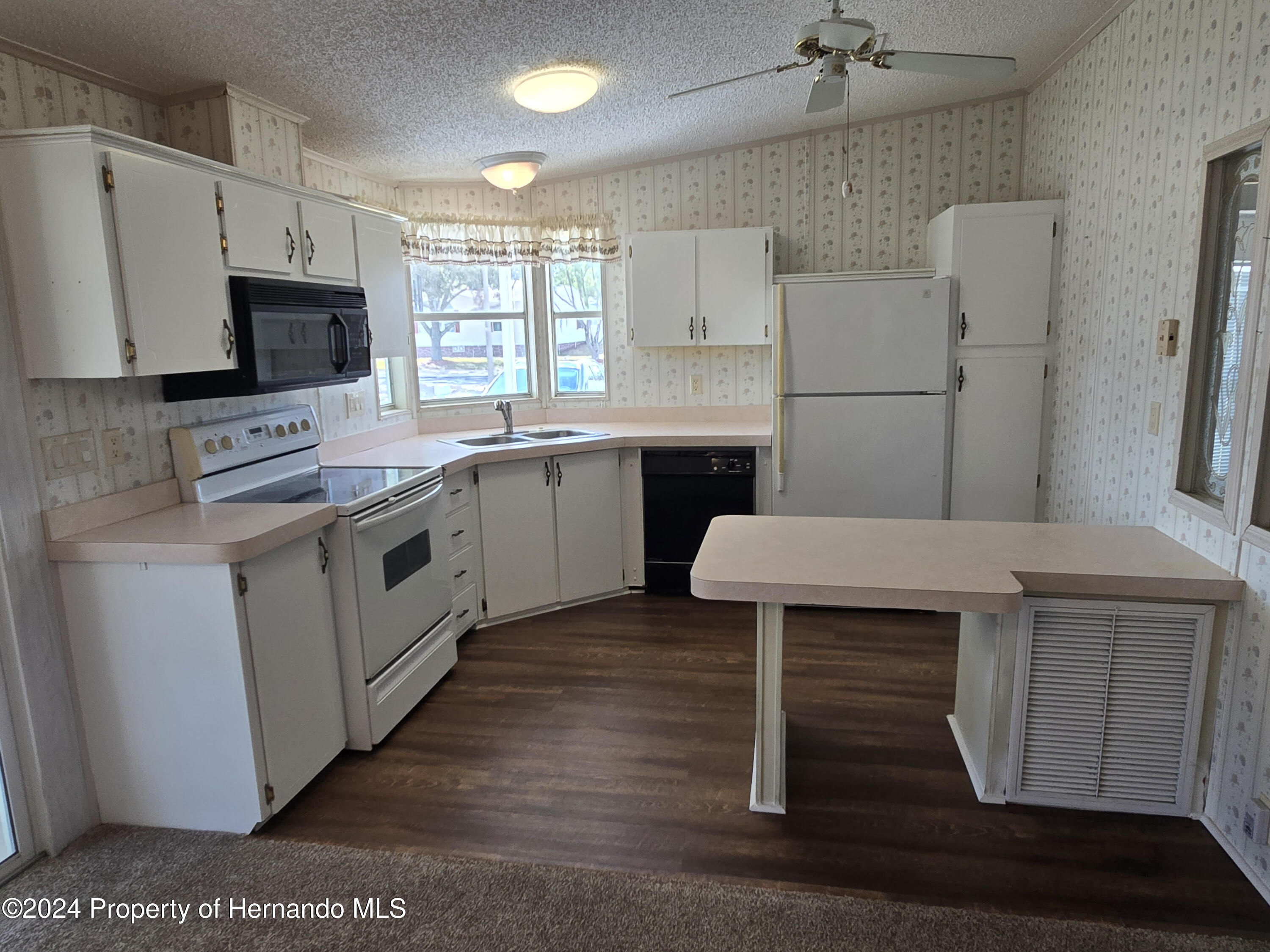 a kitchen with cabinets and stainless steel appliances