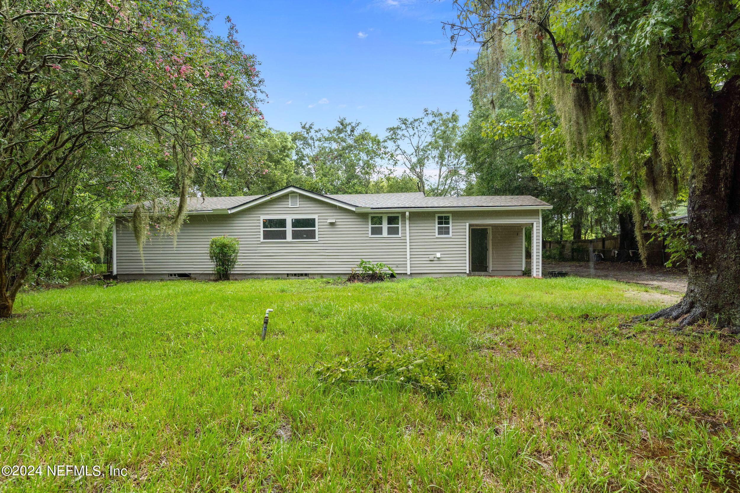 a front view of house with yard and green space