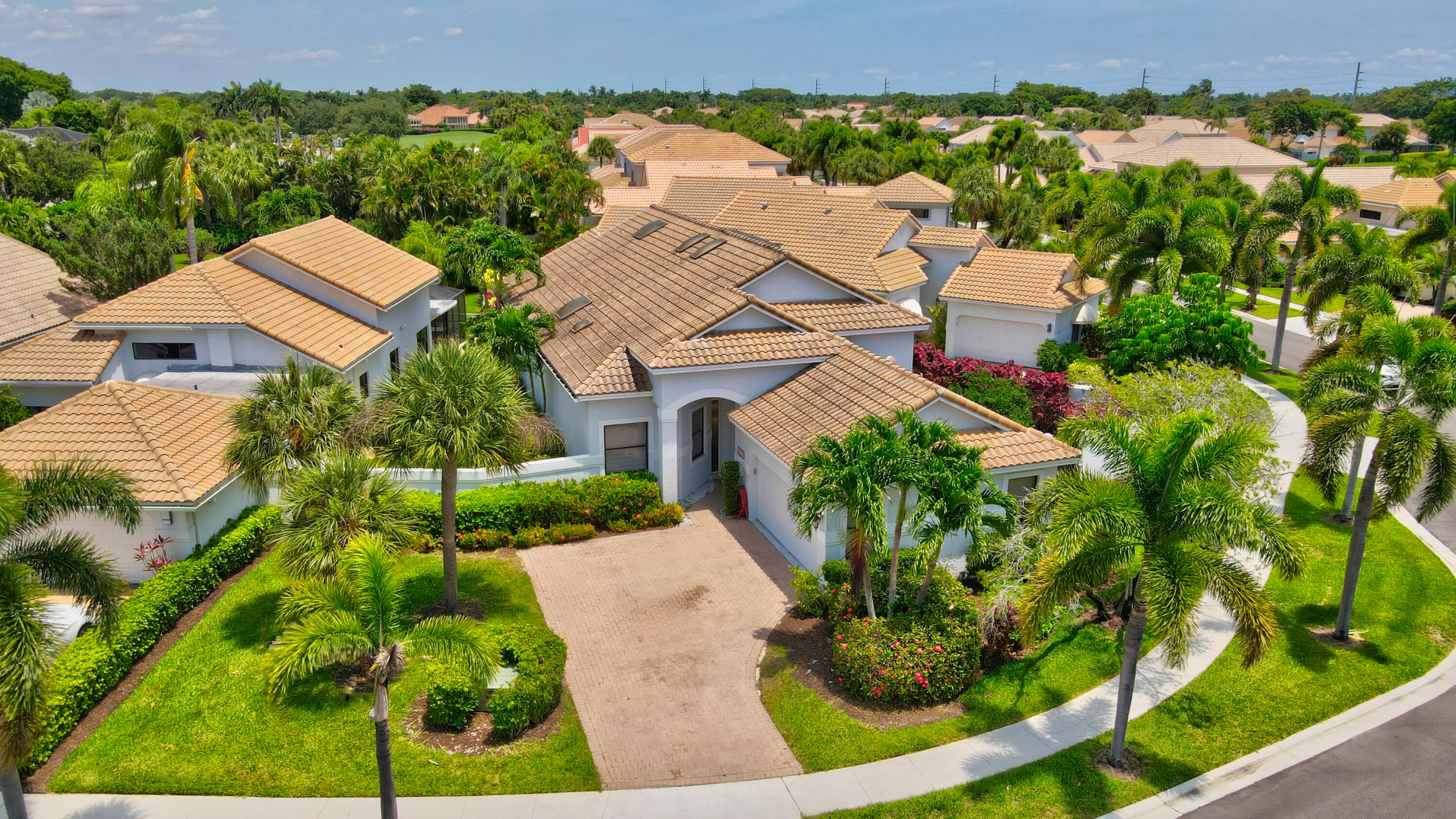 an aerial view of multiple houses with a yard