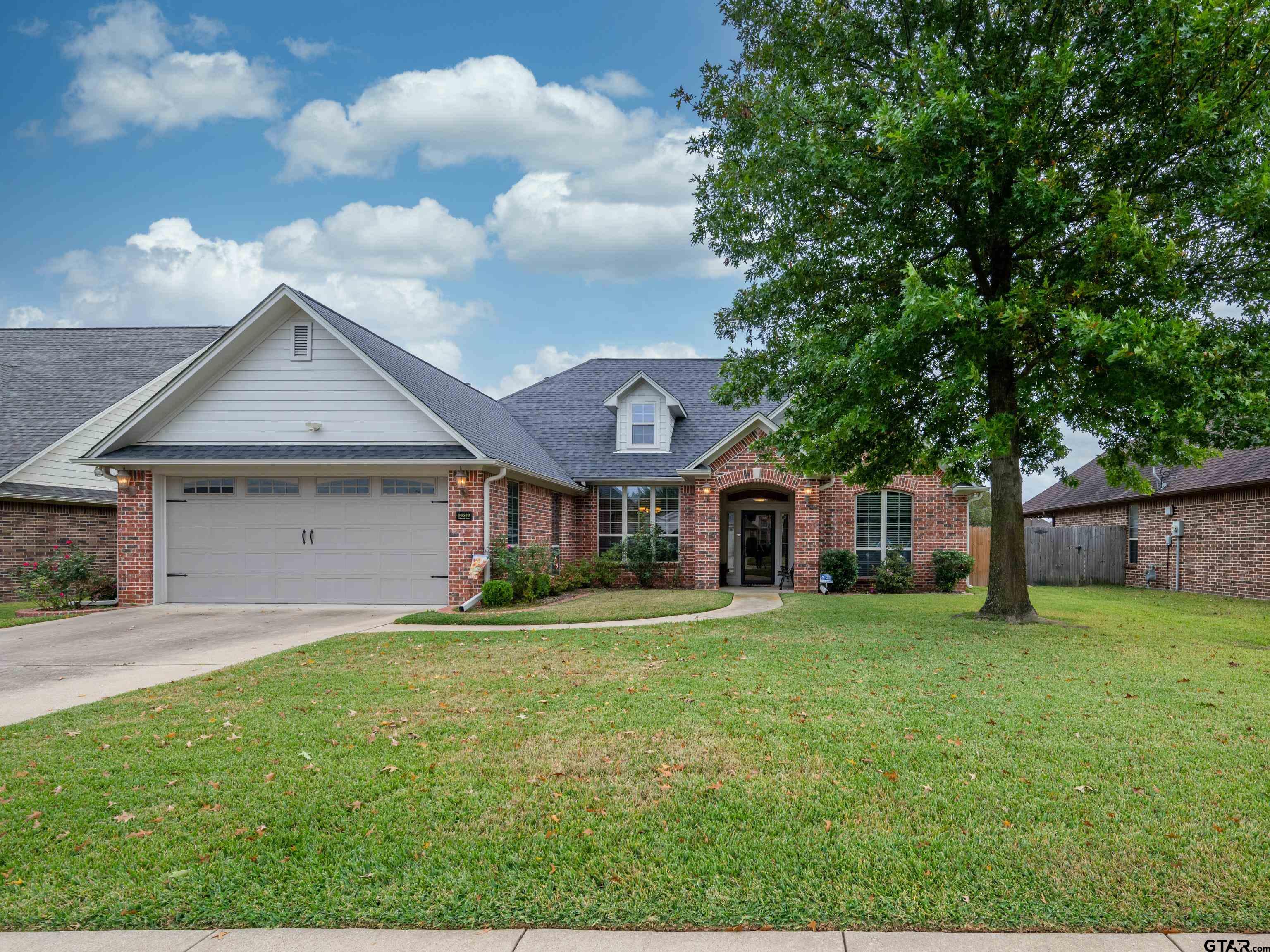 a house that has a big yard and large trees