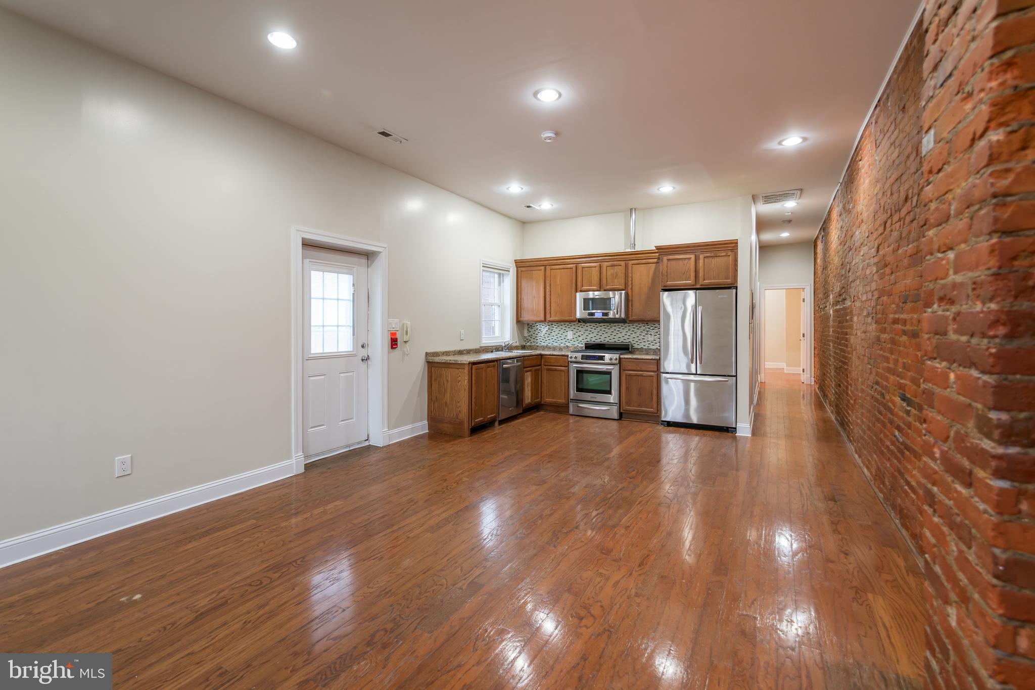 a view of kitchen with furniture and stainless steel appliances