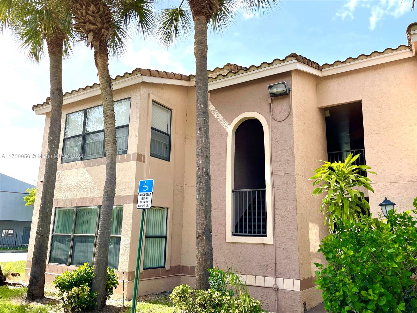 a front view of a house with a plants