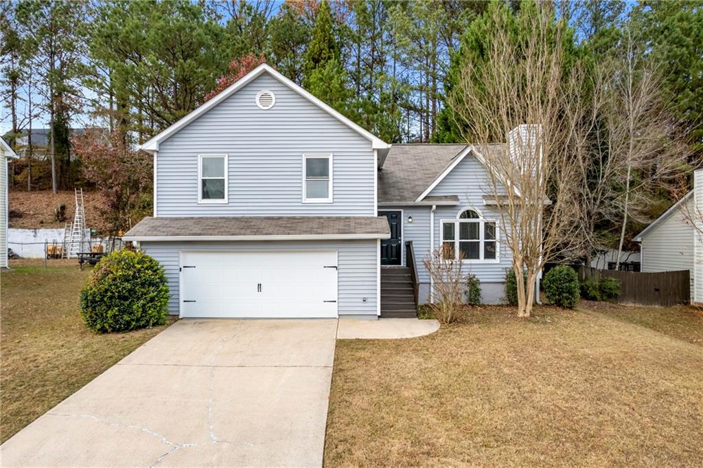 a front view of a house with a yard and garage