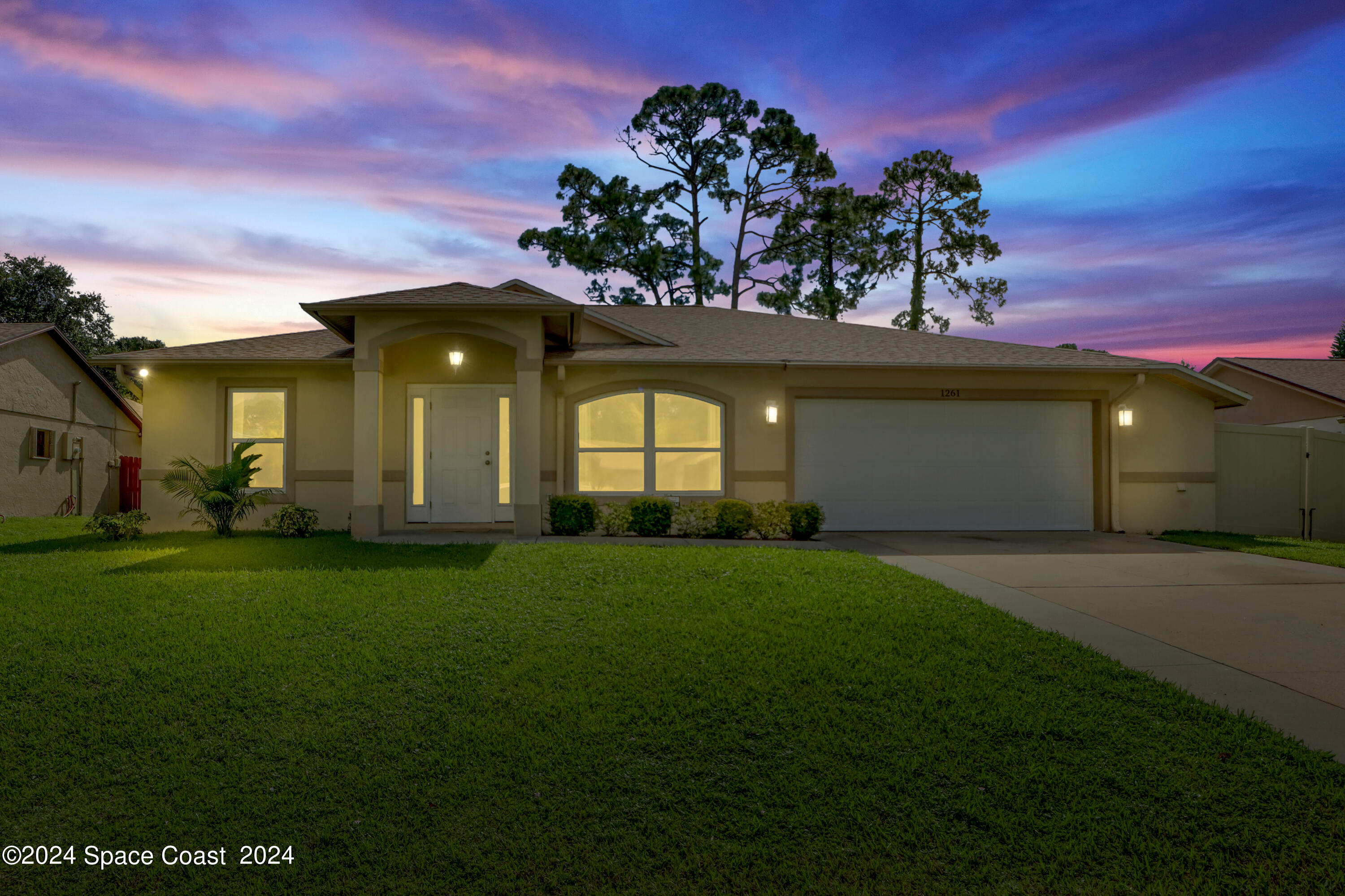 a front view of a house with a garden