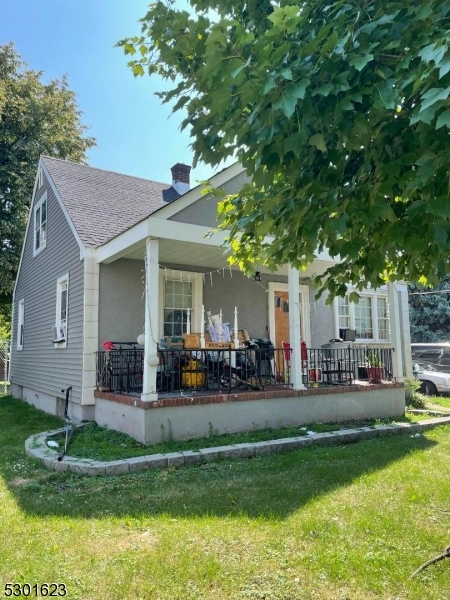 a view of a house with backyard porch and sitting area