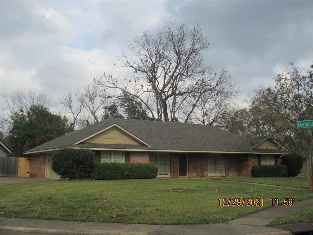 a front view of house with yard and trees