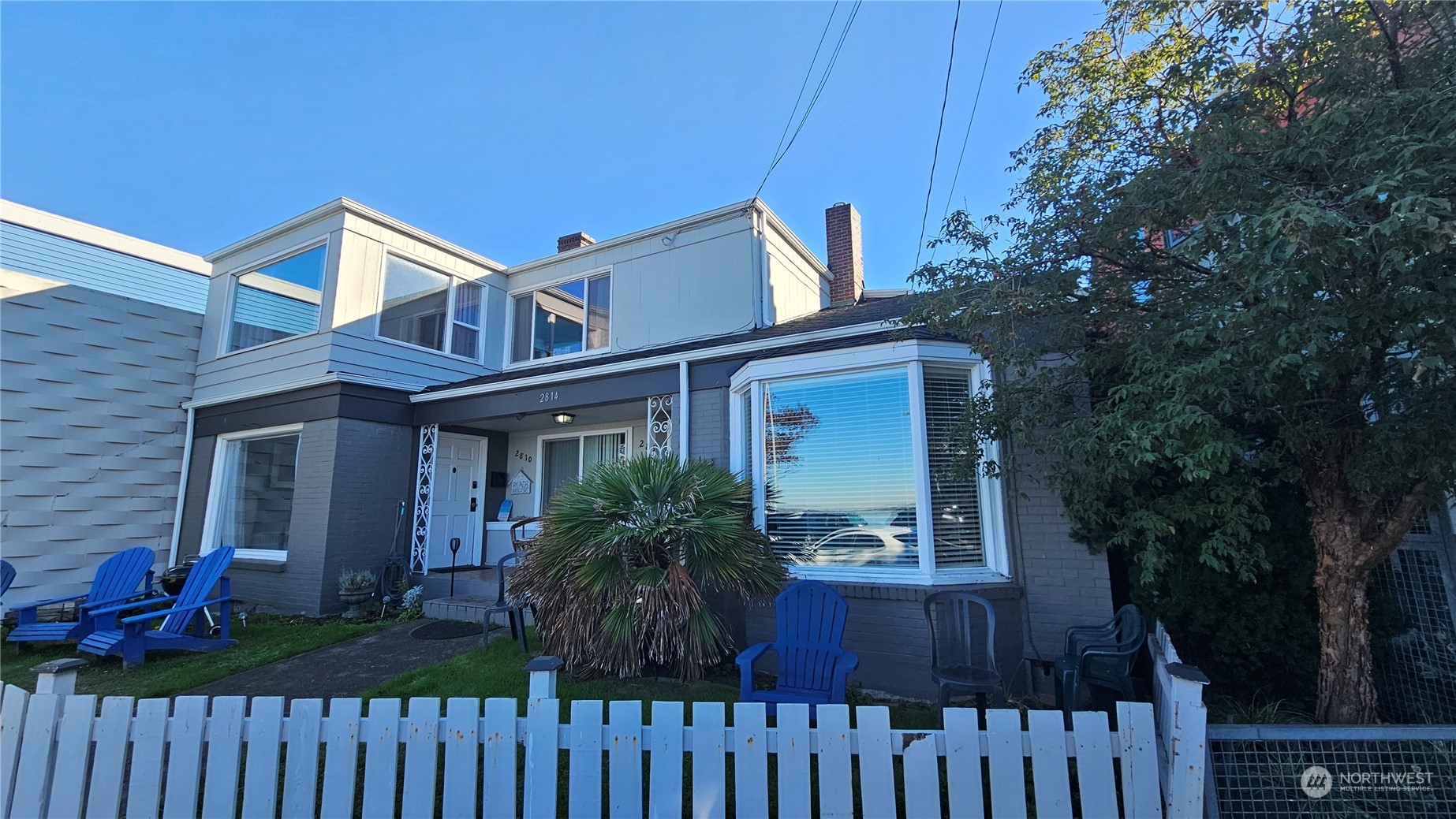 a view of a house with wooden fence and plants