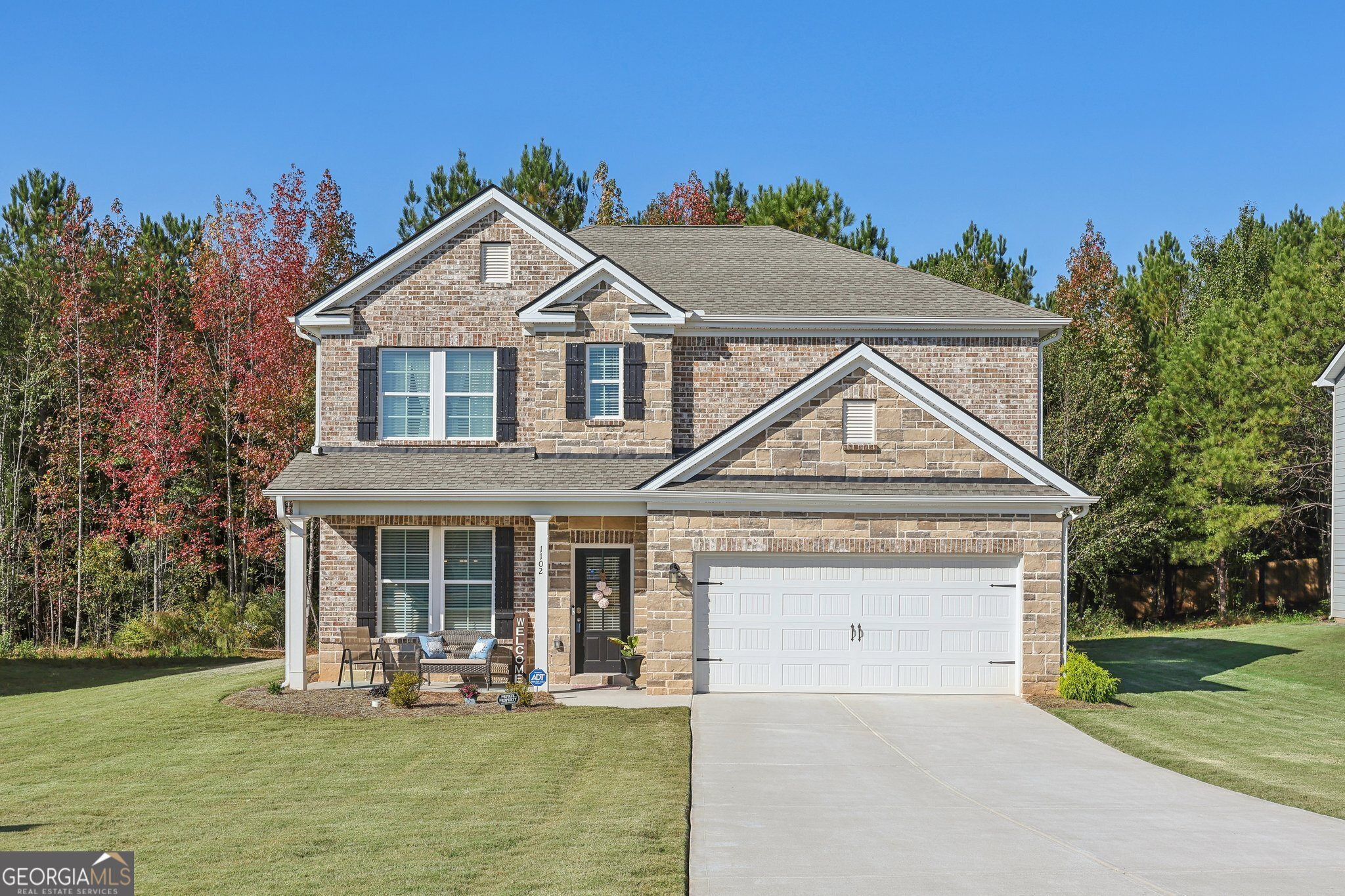 a front view of a house with garden