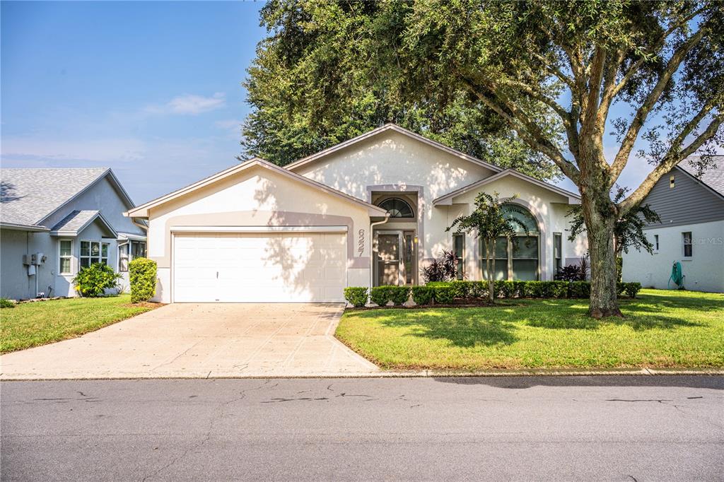 a front view of a house with a yard and garage