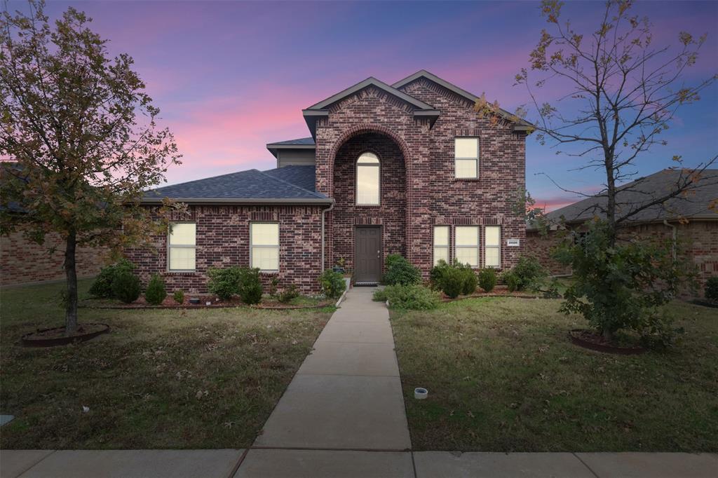 a front view of a house with yard